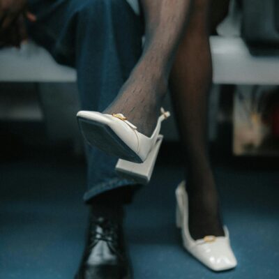 Stylish urban fashion with striking contrast of black shoe and white high heel in an urban setting.